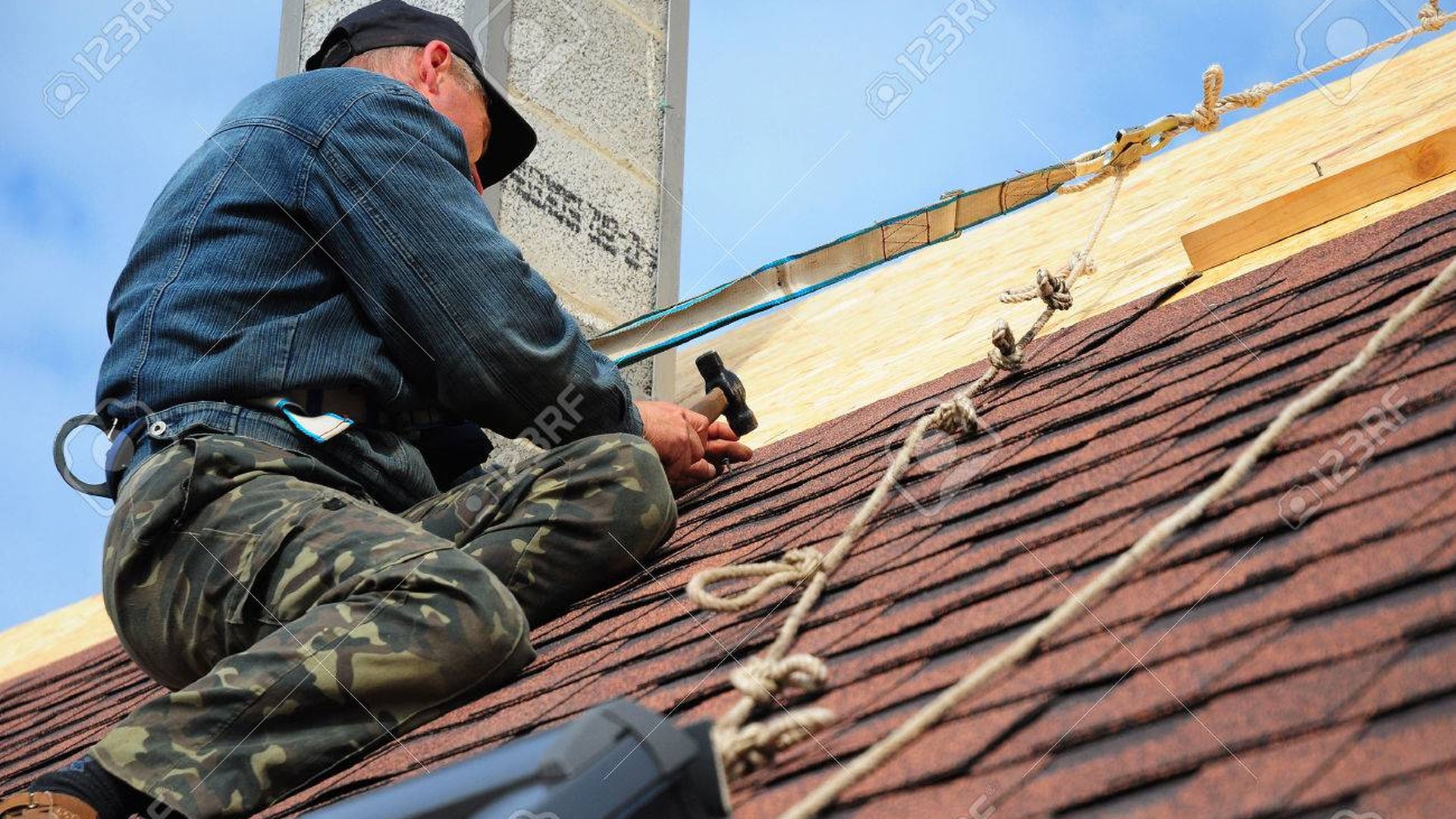 Professional roofer working on a UK roof